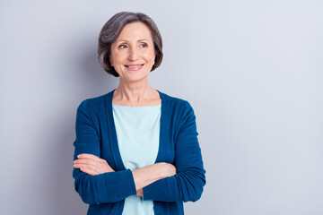 Poster - Photo portrait of elder woman curious looking copyspace with folded hands isolated on grey color background