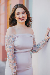 Poster - Vertical shot of a beautiful young Caucasian female posing outdoors in an elegant dress