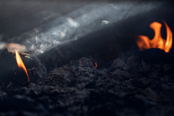 Open fire and smoke cloud from burning charcoal grill ready for product placement.