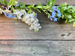  Bright blue forget-me-nots and white flowers on a wooden background. Copy space. Place for your text.