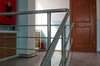 © Temir - staircase of an office space with door, tiled floor and stainless railing