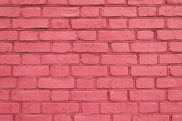 Texture of a pink brick wall laid with gray cement as a background