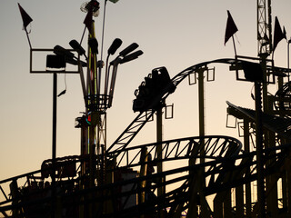 Wall Mural - Silhouette of a rollercoaster in the amusement park during the sunset