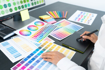 Poster - creative graphic designer choosing color scale for editing artwork while working in office.
