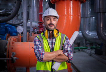 Wall Mural - Industry engineer under checking industry cooling tower air conditioner is water cooling tower air chiller HVAC of large industrial building to control air system.