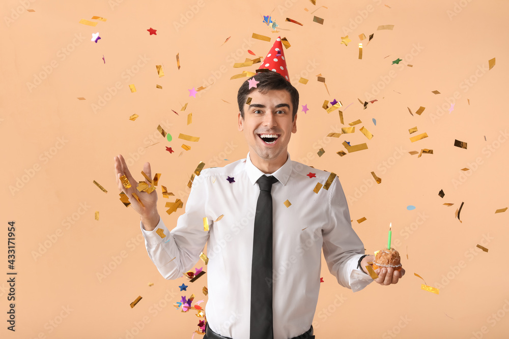 Happy man celebrating birthday on color background