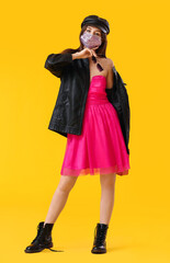 Poster - Fashionable young woman wearing mask on color background