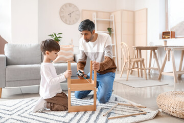 Wall Mural - Father and little son fixing chair at home