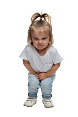 Wall Mural - Angry little girl 2-3 years old in jeans is squatting. Isolated on white background. Vertical.