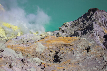 Wall Mural - Blue waters of Kawah Ijen acid lake and sulfur mines from the top of volcano. The Ijen volcano complex is a group of composite volcanoes in the Banyuwangi Regency of East Java island, Indonesia.