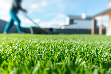 spring season sunny lawn mowing in the garden. lawn blur with soft light for background. selective f