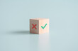 True and false symbols accept rejected for evaluation, Yes or No on wood blogs on blue background.