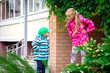 happy girl in purple dress and her brother, outdoor walks happy childhood selective focus