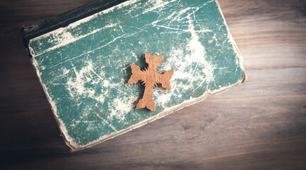 Wall Mural - Christian cross and Bible on the wooden background.