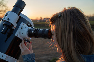 Wall Mural - woman looking at night sky with amateur astronomical telescope.