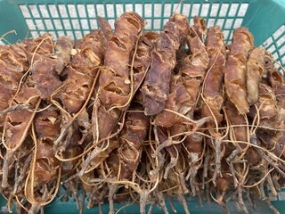 dry tamarind on green basket