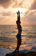 © juliagubankova - Yoga at dawn. The girl meets the sunrise at sea. The beginning of the day. Happy morning. Sports, healthy lifestyle.