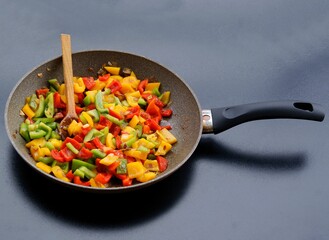 Wall Mural - frying cut vegetables on pan close up