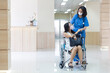© Thirawatana - Female patient on wheelchair listens to doctor. Doctor talking to an young woman in a wheelchair.