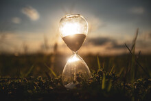 Life Time Passing Concept. Hourglass At Sunset Time. Concept Time Is Money.