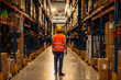 © bernardbodo - Warehouse worker oversees shelves with boxes