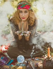 Wall Mural - Gypsy soul... Boho woman with Tarot cards, candles and magic ball at field, lifestyle, predicting, ideas for costume on Halloween