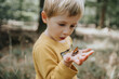 © Mareen Fischinger/Westend61 - Surprised boy looking at butterfly on palm of hand