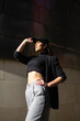 © Mikel Taboada/Westend61 - Fashionable woman with hand on hip adjusting cap