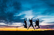 © CSSHOT/Westend61 - Carefree female friends with arms raised jumping in front of sky