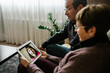 © Xavier Lorenzo/Westend61 - Grandparents on video call with granddaughter through digital tablet at home