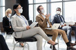 © LIGHTFIELD STUDIOS - young businessman pointing with hand near interracial colleague in medical masks