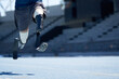 © Trevor Adeline/Caia Image - Male amputee athlete sprinting on sunny blue sports track