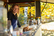 © Martin Barraud/Caia Image - Portrait happy female food cart owner working in park