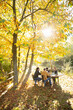 © Martin Barraud/Caia Image - Business people working at table in sunny idyllic autumn park