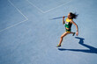 © Trevor Adeline/Caia Image - Female track and field athlete throwing javelin on sunny blue track