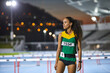 © Trevor Adeline/Caia Image - Portrait determined track and field athlete on track at night