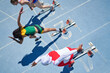 © Trevor Adeline/Caia Image - Female track and field athletes taking off from starting blocks