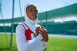 © Trevor Adeline/Caia Image - Determined female track and field athlete preparing to throw discus