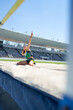 © Trevor Adeline/Caia Image - Happy female track and field athlete celebrating high jump