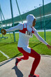 © Trevor Adeline/Caia Image - Female track and field athlete in hijab throwing discus