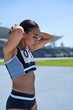 © Trevor Adeline/Caia Image - Determined female track and field athlete on sunny track