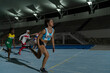 © Trevor Adeline/Caia Image - Female track and field runner crossing finish line