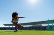 © Trevor Adeline/Caia Image - Female track and field athlete throwing shot put in sunny stadium
