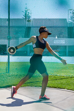 Female Track And Field Athlete Throwing Discus