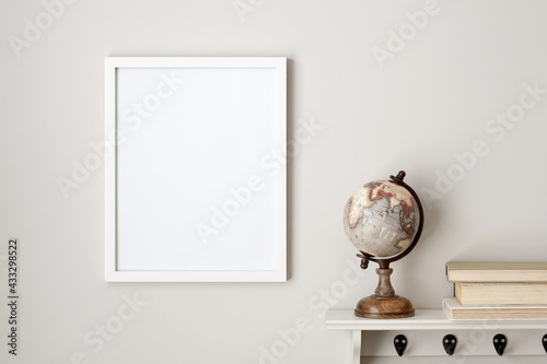Download 11x14 Thin White Vertical Frame Mockup Hanging On A Neutral Coloured Wall Next To A White