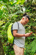 © Hector Pertuz - Hispanic Man Using Phone In Tropical Forest