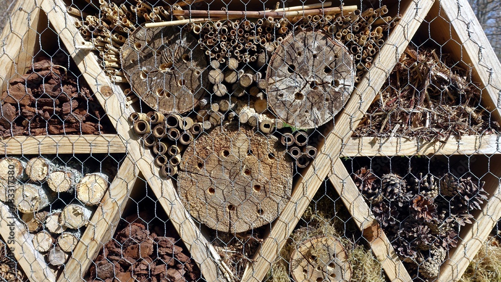 Insect hotel. Wooden structure filled with natural material ready to ...