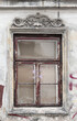 A window on the facade of an old tenement house. 