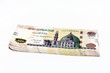Stack of 200 Egyptian pounds banknote year 2020, obverse side has an image of Mosque of Qani-Bay Cairo, Egypt. The reverse side has an image of The Seated Scribe isolated on white background