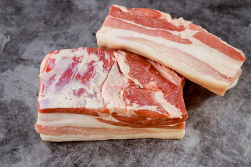 Wall Mural - Fresh uncooked pork belly on dark background.